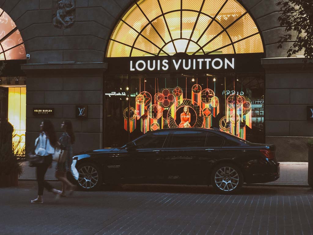 luxury car in front of store front