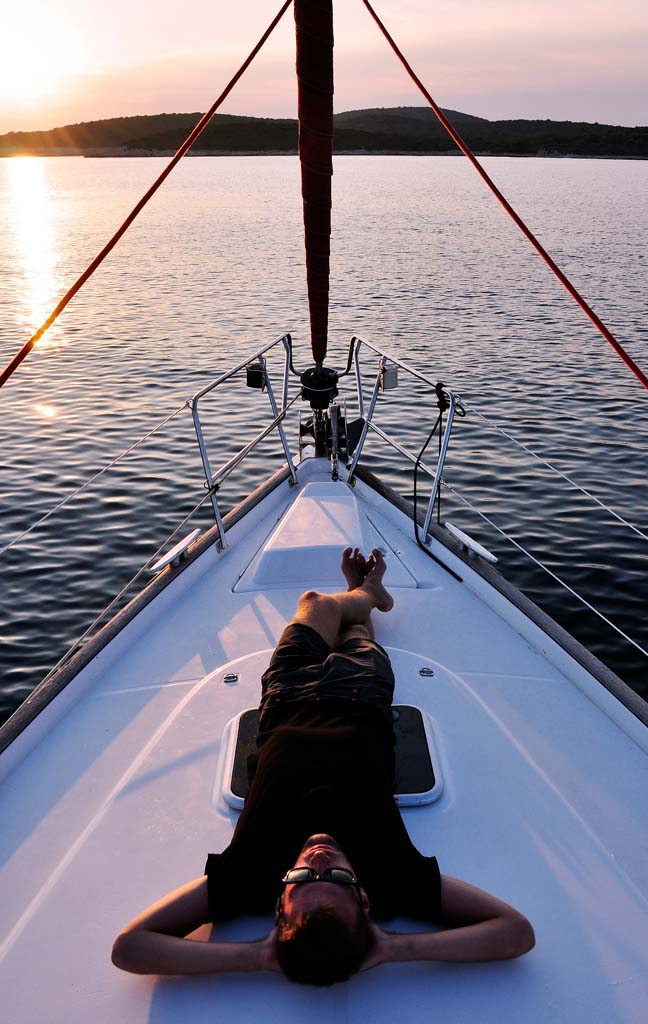 Front of a yacht with woman sunbathing